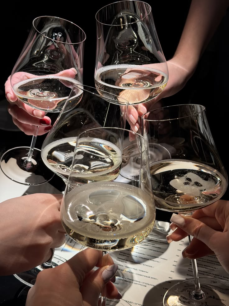 A toast at the soft opening, glasses raised in warm light