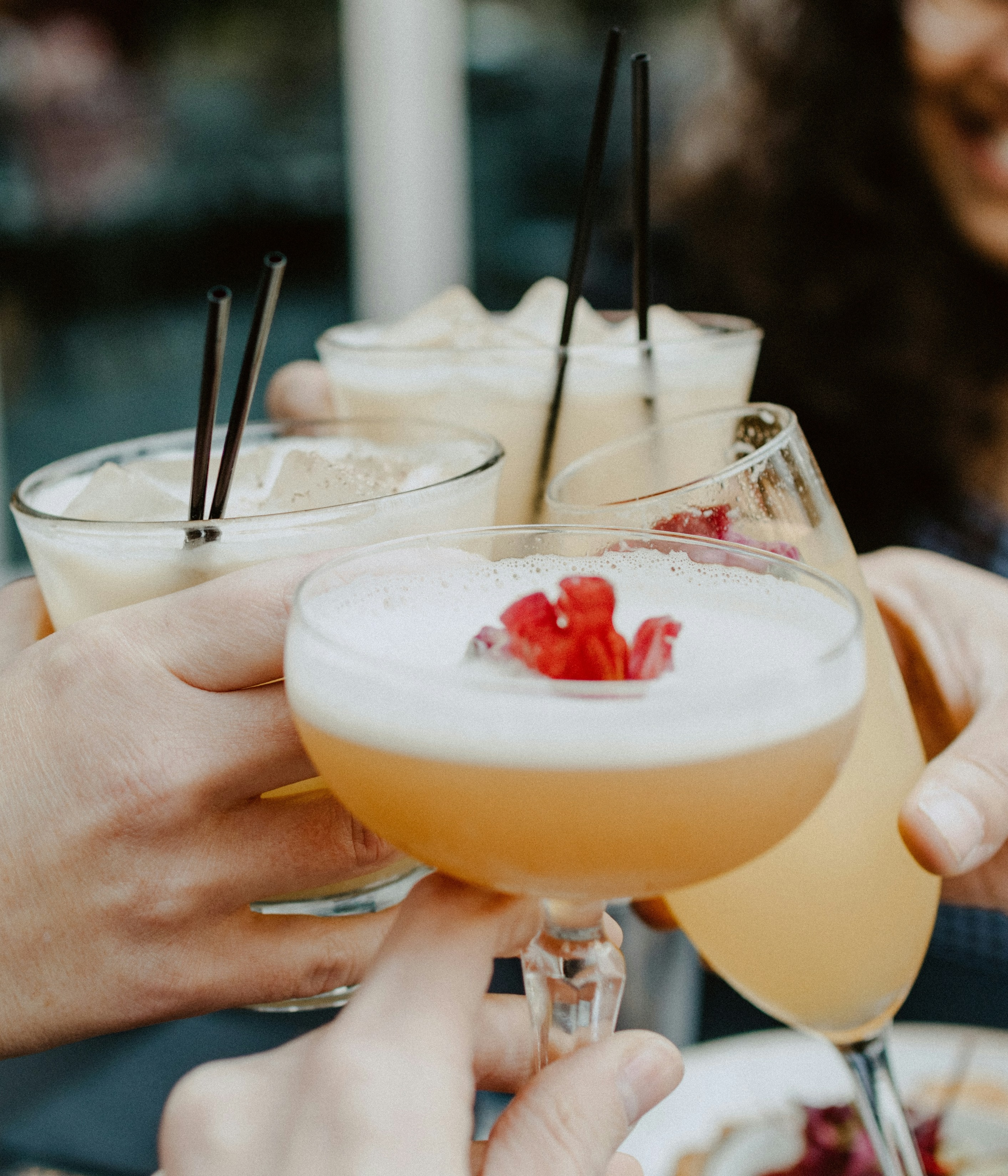 A toast at the soft opening, glasses raised in warm light